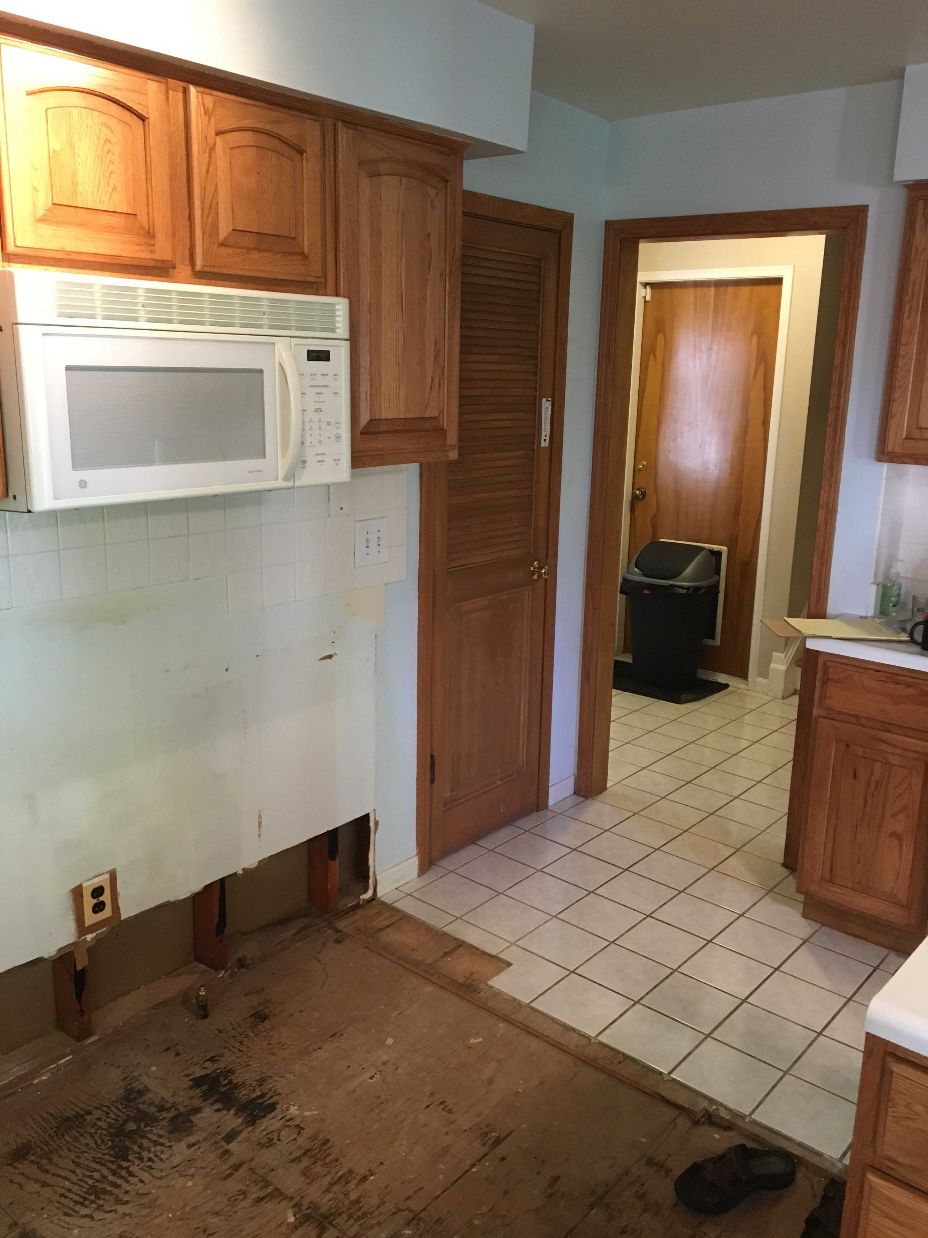 black mold in kitchen wood floor after water damage in Ann Arbor