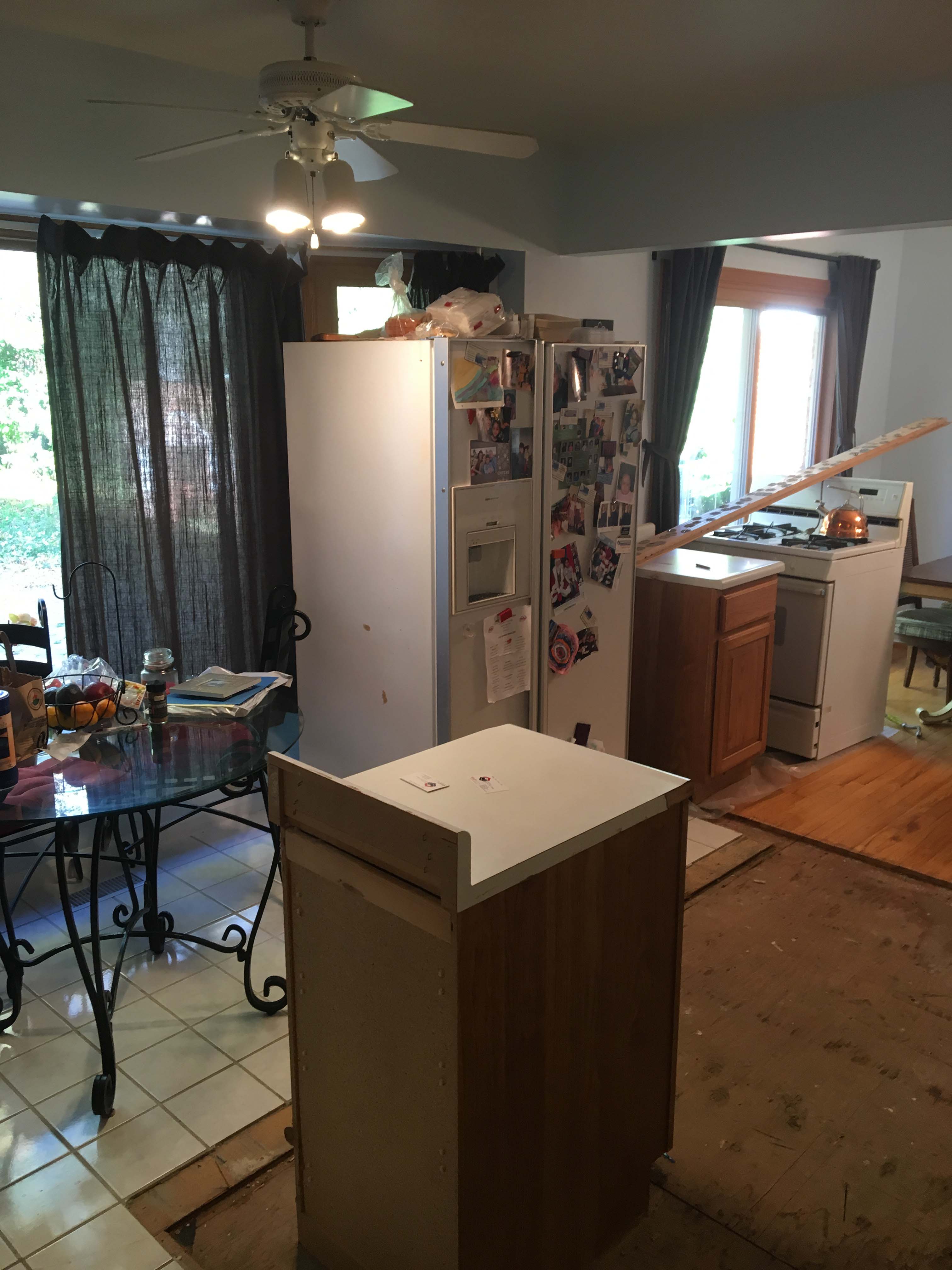 damaged wood kitchen floor with water and black mold
